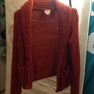 A knit dark orange cardigan
